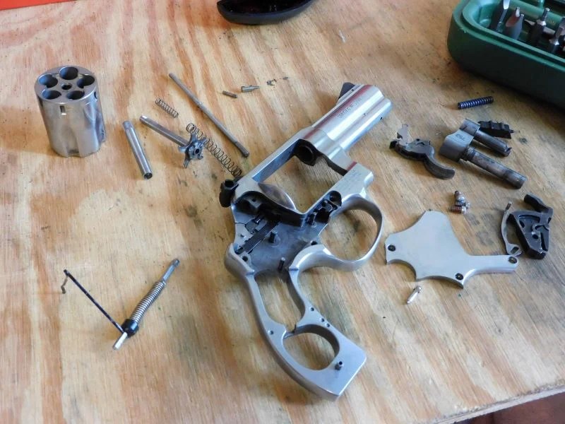 Photo of a disassembled Smith & Wesson revolver.